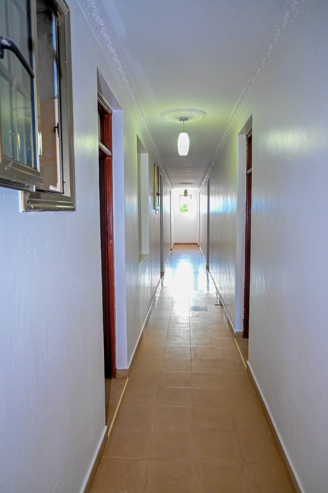 A bright, quiet corridor leading to the guest rooms